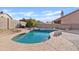 Backyard featuring a lagoon style pool, stone accents, and mature landscaping at 3106 E Hiddenview Dr, Phoenix, AZ 85048