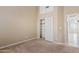 Bedroom with a closet with sliding doors, neutral walls and carpet, and doorway leading to another room at 3106 E Hiddenview Dr, Phoenix, AZ 85048