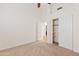 Bedroom with a closet with sliding doors, neutral walls and carpet, and doorway leading to another room at 3106 E Hiddenview Dr, Phoenix, AZ 85048