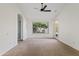 Bright bedroom with a ceiling fan, en-suite bathroom and a backyard view from the window at 3106 E Hiddenview Dr, Phoenix, AZ 85048