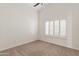 Bedroom with neutral walls and carpet, large window with plantation shutters, and ceiling fan at 3106 E Hiddenview Dr, Phoenix, AZ 85048