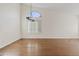 Bright living room with hardwood floors, chandelier, and large windows with white shutters at 3106 E Hiddenview Dr, Phoenix, AZ 85048