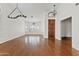 Bright living room with hardwood floors, chandelier, and large windows with white shutters at 3106 E Hiddenview Dr, Phoenix, AZ 85048