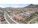 Aerial view of houses and neighborhood with mountain views at 31817 N 124Th Dr, Peoria, AZ 85383