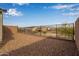 Spacious backyard with gravel and a metal fence, providing privacy at 31817 N 124Th Dr, Peoria, AZ 85383