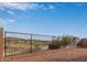 Modern black metal fence encloses backyard, offering privacy and a view of the neighborhood at 31817 N 124Th Dr, Peoria, AZ 85383