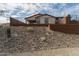 Home's back elevation with rock landscaping at 31817 N 124Th Dr, Peoria, AZ 85383