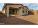 Home's back elevation, patio, and gravel yard at 31817 N 124Th Dr, Peoria, AZ 85383