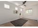 Bright bedroom with wood floors, window shutters, and ceiling fan at 31817 N 124Th Dr, Peoria, AZ 85383