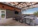 Outdoor patio area with covered seating and a TV at 31817 N 124Th Dr, Peoria, AZ 85383