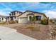 Single-story home with a beige exterior, brick driveway, and desert landscaping at 31817 N 124Th Dr, Peoria, AZ 85383