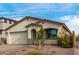 Single-story home with a beige exterior, brick driveway, and desert landscaping at 31817 N 124Th Dr, Peoria, AZ 85383