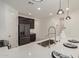 Modern kitchen island with white quartz countertops and stainless steel sink at 31817 N 124Th Dr, Peoria, AZ 85383