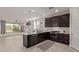 Modern kitchen with dark wood cabinets and stainless steel appliances at 31817 N 124Th Dr, Peoria, AZ 85383