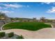 Landscaped lawn area with winding pathway at 31817 N 124Th Dr, Peoria, AZ 85383