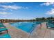 Relaxing pool area with numerous lounge chairs at 31817 N 124Th Dr, Peoria, AZ 85383