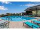 Community pool with surrounding lounge chairs at 31817 N 124Th Dr, Peoria, AZ 85383