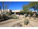 Single story home with desert landscaping and walkway at 34457 N Legend Trail Pkwy # 2008, Scottsdale, AZ 85262