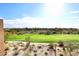 Scenic view of a golf course with houses and mountains in the distance at 34457 N Legend Trail Pkwy # 2008, Scottsdale, AZ 85262