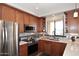 Modern kitchen with stainless steel appliances and wood cabinets at 34457 N Legend Trail Pkwy # 2008, Scottsdale, AZ 85262