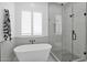 Clean bathroom with a free-standing bathtub and a walk-in shower at 3588 W New Life Ln, Queen Creek, AZ 85144