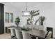 Elegant dining room with dark wood table, grey chairs, and modern art at 3588 W New Life Ln, Queen Creek, AZ 85144