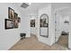 Bright hallway with wood floors, framed photos, and a large arch mirror at 3588 W New Life Ln, Queen Creek, AZ 85144