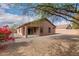 Landscaped backyard with gravel, covered patio, and mature trees at 3663 S Hassett --, Mesa, AZ 85212