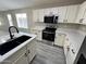 Updated kitchen featuring white cabinets, quartz countertops and a stylish black sink at 3663 S Hassett --, Mesa, AZ 85212