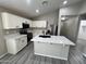 Modern kitchen with white cabinets, quartz countertops, and stainless steel appliances at 3663 S Hassett --, Mesa, AZ 85212