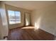 Bright bedroom with wood floors and large window at 3840 N 43Rd Ave # 48, Phoenix, AZ 85031