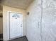 White door entry to condo unit with light fixture at 3840 N 43Rd Ave # 48, Phoenix, AZ 85031