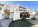 Front view of a two-story townhome with a balcony and landscaping at 3840 N 43Rd Ave # 48, Phoenix, AZ 85031