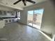 Kitchen with light cabinets, tile floor, and access to patio at 3840 N 43Rd Ave # 48, Phoenix, AZ 85031