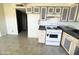 Bright kitchen features white appliances and dark countertops at 3840 N 43Rd Ave # 48, Phoenix, AZ 85031