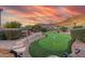 Landscaped backyard with putting green and sunset views at 4202 S Cordia Ct, Gold Canyon, AZ 85118