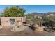 Outdoor kitchen, fire pit, and seating area in a desert landscape at 4202 S Cordia Ct, Gold Canyon, AZ 85118