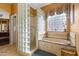 Spa-like bathroom with soaking tub, glass block shower, and granite at 4202 S Cordia Ct, Gold Canyon, AZ 85118