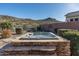 Hot tub nestled in a stone enclosure with mountain views at 4202 S Cordia Ct, Gold Canyon, AZ 85118