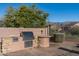 Outdoor kitchen with built-in grill and stone countertops at 4202 S Cordia Ct, Gold Canyon, AZ 85118