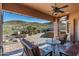 Covered patio with mountain views, fire pit, and comfortable seating at 4202 S Cordia Ct, Gold Canyon, AZ 85118