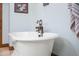 Close-up of a white clawfoot bathtub with dark bronze faucet at 424 E Lehi Rd, Mesa, AZ 85203