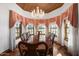 Formal dining room with hardwood floors, chandelier, and decorative curtains at 424 E Lehi Rd, Mesa, AZ 85203