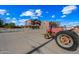 Large home with a spacious driveway and a red tractor at 424 E Lehi Rd, Mesa, AZ 85203