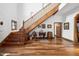 Grand entryway with hardwood floors and wooden staircase at 424 E Lehi Rd, Mesa, AZ 85203