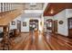 Grand entryway with hardwood floors, wooden staircase, and views into the living room and kitchen at 424 E Lehi Rd, Mesa, AZ 85203