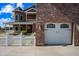 Brick home with wrap-around porch, white picket fence, and attached garage at 424 E Lehi Rd, Mesa, AZ 85203