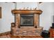 Brick fireplace with wooden mantel in the living room at 424 E Lehi Rd, Mesa, AZ 85203