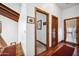 Upstairs hallway with hardwood floors and doors to other rooms at 424 E Lehi Rd, Mesa, AZ 85203