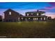 Brick house exterior with large porch at dusk at 424 E Lehi Rd, Mesa, AZ 85203